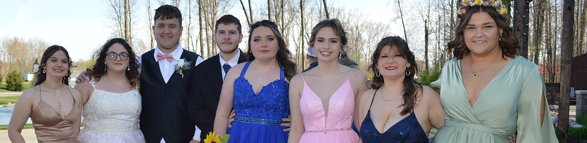 Group of happy students posing for a picture at the prom