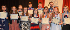 students at an Academic Honor Banquet with their awards